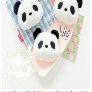 Close-up view of adorable soft plush panda head accessories for clothing and bags decoration