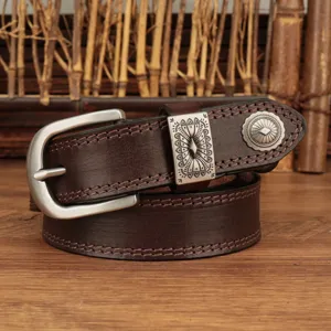 Vintage brown leather belt with silver metal buckle and decorative carved loop detail.