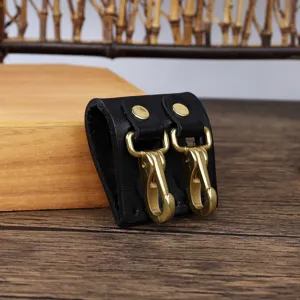 Durable black leather belt key holder featuring dual brass hooks for secure waist carrying.