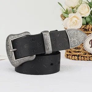 Detailed view of black leather belt featuring ornate silver buckle and vintage embossed pattern.