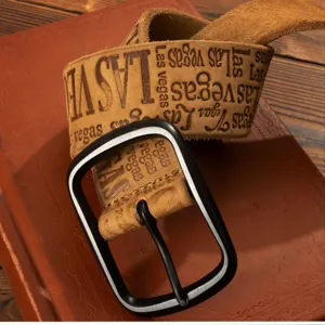 Retro men's leather belt with Las Vegas embossed text and black metal buckle detail view.