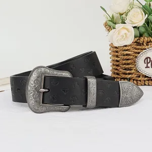 Vintage floral embossed leather belt detail showing ornate silver metal buckle and strap texture.