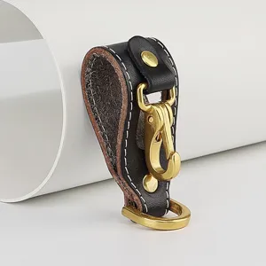 Genuine leather belt keychain detail, brass hook and D-ring, sturdy hardware accessory.