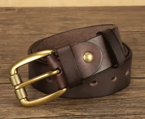 Detailed shot of men's retro brown leather belt with vintage metal roller pin buckle.