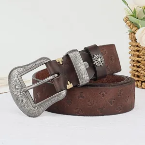 Vintage genuine leather embossed women belt detail view showcasing intricate carved metal buckle.