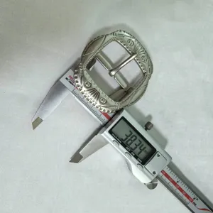 Vintage alloy pin buckle detail showing 38mm size measurement with a digital caliper.