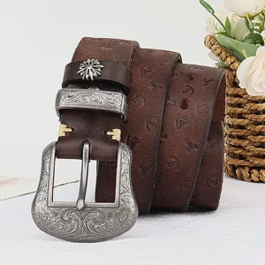 Vintage genuine leather women belt with floral engraved metal buckle and embossed strap details.