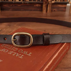 Detailed view of women's dark brown leather belt with vintage brass buckle and leather loop.