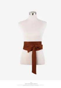 Detailed view of the brown suede waist belt, featuring a classic bow tie design for dresses.