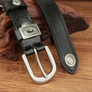 Detailed close-up view of women's vintage black leather belt featuring ornate silver metal buckle.