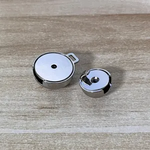 Detailed view of two silver metal belt buckles for elegant dress waist adjustment