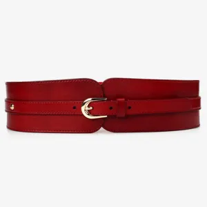 Close-up detail of the wide red leather waist belt featuring a gold metal buckle and strap.