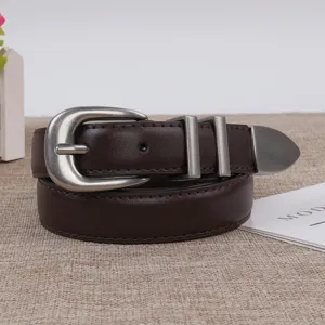 Detail view of a women's dark brown leather belt featuring vintage silver metal buckle and tip.