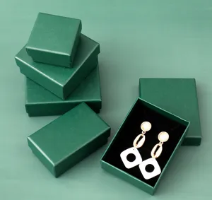 Detail view of peacock green jewelry gift boxes with black velvet lining for earrings