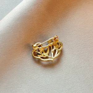 Gold tone retro Chinese style brooch back detail close-up, elegant craft ornament.