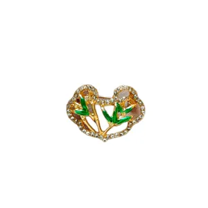 Vintage Chinese style Ruyi cloud brooch with green enamel and rhinestones for suits.
