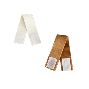Pair of soft plush fabric backpack straps in solid cream and brown with Velcro fasteners
