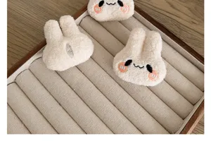 Macro detail view of soft plush long-eared bunny heads for DIY craft accessories