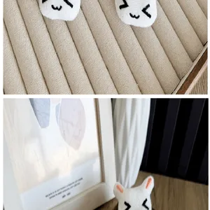 Detailed macro shot of cute white plush rabbit head with embroidered kawaii face