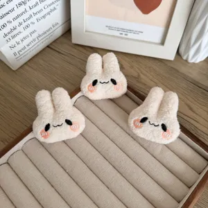 Set of three cute beige plush bunny heads DIY accessories displayed on a jewelry tray