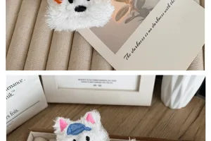 Detailed view of cute plush Westie dog brooch with colorful embroidered ears