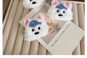 Close-up of white plush West Highland Terrier dog accessory with blue cap