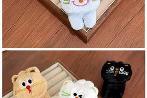 Close-up of cute 3D plush cartoon cat hair clips featuring detailed facial embroidery