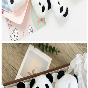 Macro view of cute cartoon panda plush head accessories for DIY clothing and crafts