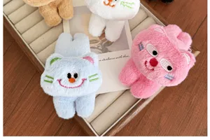 Detail view of cute cartoon cat plush hair clips in various colors on jewelry tray
