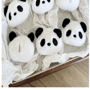 Close-up view of cute panda plush head accessories for DIY crafts, brooches and bags