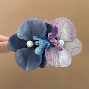 Large blue and purple Phalaenopsis orchid hair clip with pearl accents for elegant hairstyles