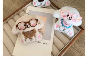 Close-up view of handmade cute plush puppy dog charms wearing miniature colorful glasses
