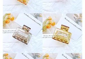 Detailed view of hollow geometric hair claw clips in amber and smoky grey colors