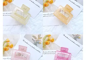 Set of minimalist geometric hollow hair claws in four elegant translucent colors.