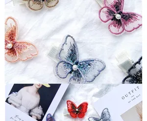 Detailed view of colorful embroidered butterfly hair clips with elegant pearl accents