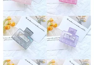 Close-up detail of hollow geometric hair claw clips in translucent purple and gray-blue