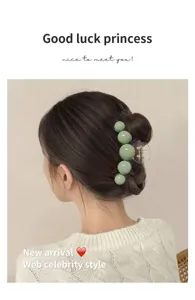 Detailed back view of a model wearing a light green bubble claw clip for a hair bun