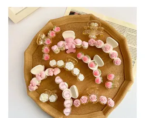 Sammlung süßer Haarspangen mit rosa Kamelien, Pfirsichen und Herzen für Damen.
