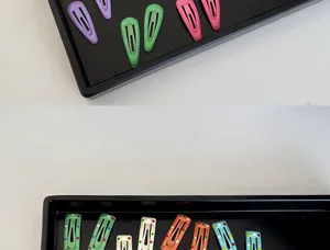 Detailed view of colorful mini baby hair clips with polka dots and solid colors