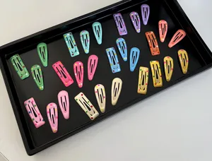 Detailed macro view of colorful polka dot mini BB hair clips in various macaron shades
