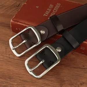 Detail view of vintage leather belts with polished silver-tone metal pin buckles