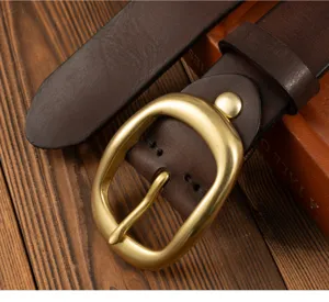 Retro women's genuine leather belt with stylish brass pin buckle, casual denim accessory.