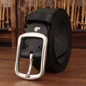 Close-up of a vintage black leather belt with a polished silver-tone pin buckle.