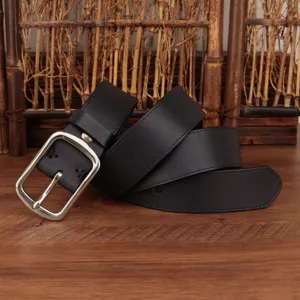 Detail of a vintage black genuine leather belt with a classic silver pin buckle.