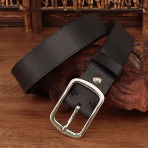 Detail view of vintage black genuine leather belt with classic silver pin buckle