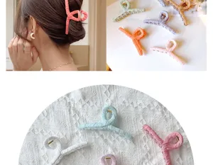 Close-up showing various colors and soft fabric texture of large hair claw clips.
