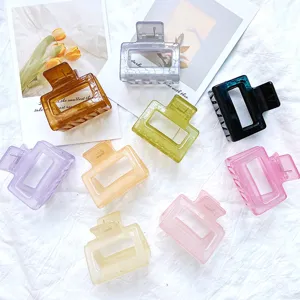 Assorted colorful geometric hollow hair claw clips with a matte and translucent finish