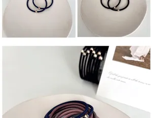 Close-up of minimalist high-elastic hair ties with polished gold beads