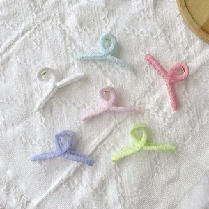 Set of six large fabric-wrapped hair claw clips in pastel colors for women