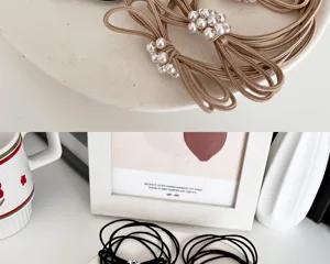 Detailed close-up view of elastic pearl bow hair ties in beige, brown and black colors